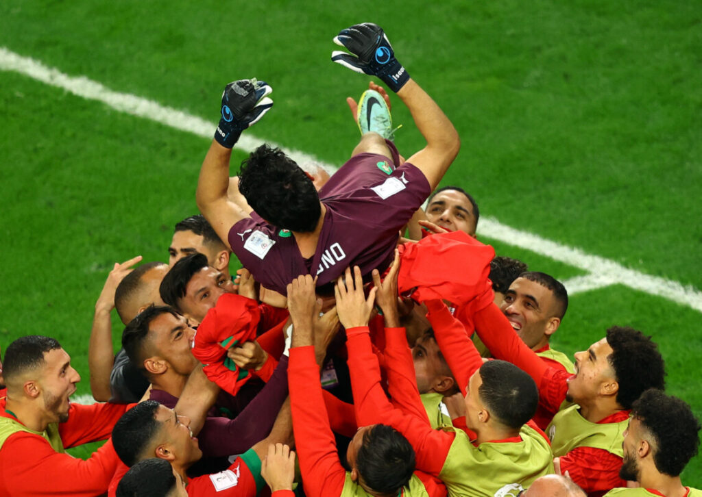 Jogadores do Marrocos comemoram com goleiro Yassine Bounou após vitória nos pênaltis contra Espanha. (REUTERS/Lee Smith)